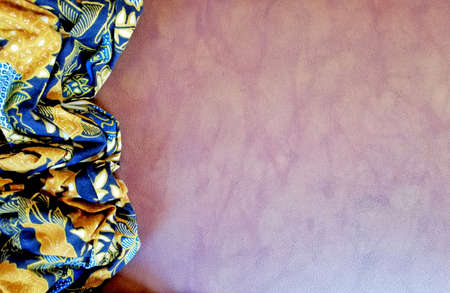 Traditional Indonesian Batik cloth,placed on brown color  background