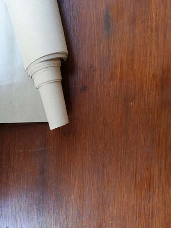 Rools of brown papers,placed on brown wooden background