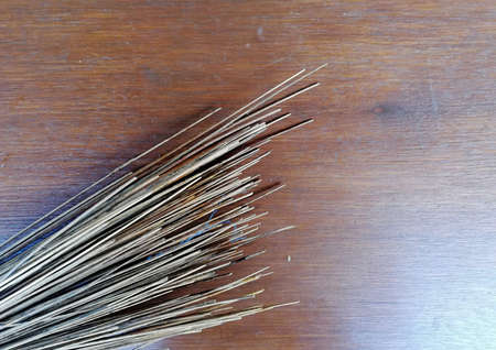 Broomstick placed on brown wooden tableの写真素材