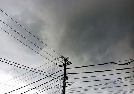 Electric cables on the street against sky