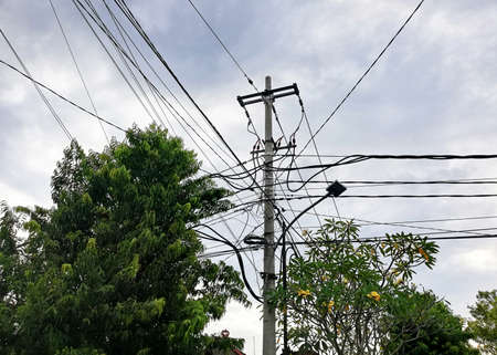 Electric cables on the street against sky