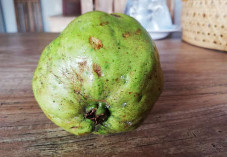 One Guava fruit placed on brown wooden tableの写真素材
