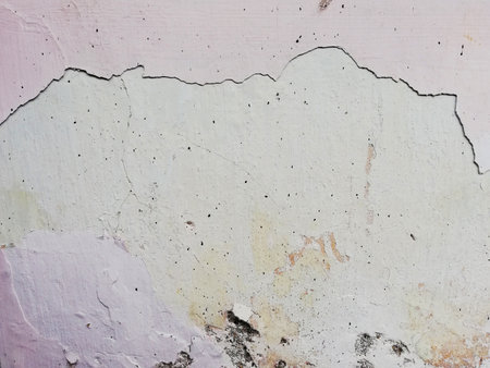 Close up of cracked,weathered,old wall backgroundの写真素材