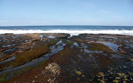 Rock formation at the south area of Bali island,with black sand beach