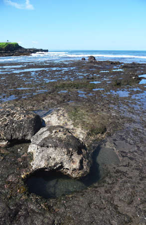 Rock formation at the south area of Bali island,with black sand beach