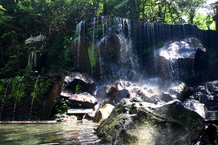 Goa Raja Waterfall, at Bangli regency of Bali, with beautiful green nature landscape surroundingsの写真素材