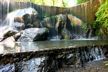Goa Raja Waterfall, at Bangli regency of Bali, with beautiful green nature landscape surroundingsの写真素材