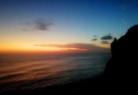 Beautiful sunset at Uluwatu temple Bali Indonesiaの写真素材