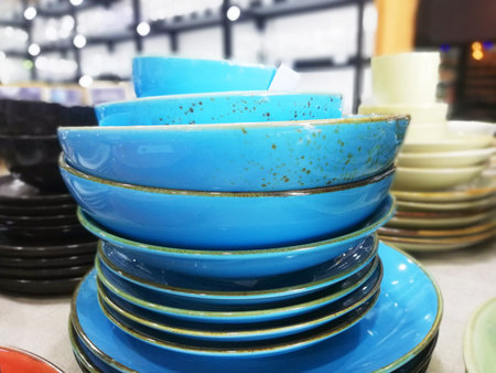 Ceramic plates and bowls in the store. Selective focus.の写真素材