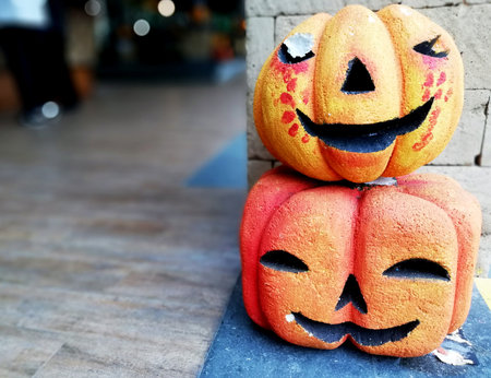 Halloween pumpkins with scary faces on the stone wall background.の写真素材