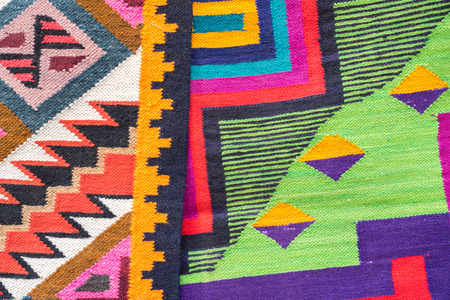Close up peruvian fabric souvenir's pattern. The souvenir is handmade with colorful dyed wool.
