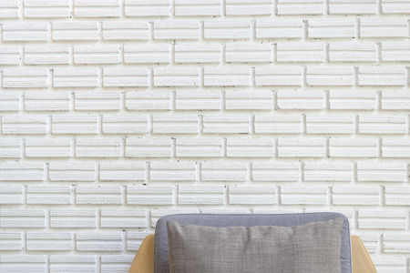 cozy sofa corner with white brick wall in industrial style. Sofa is made with handmade fabric and wood in scandinavian styleの写真素材