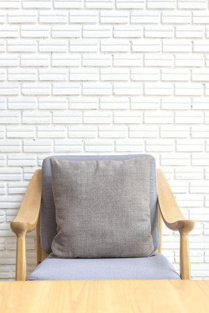 cozy sofa corner with white brick wall in industrial style. Sofa is made with handmade fabric and wood in scandinavian styleの写真素材