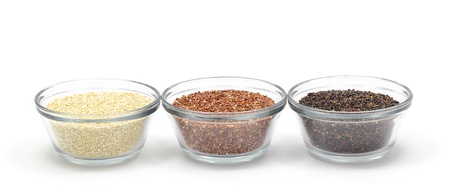 Yellow, red, and black quinoa in glass bowls isolated on a white background.の写真素材