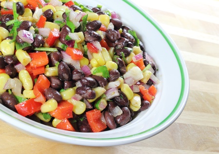 Southwest Black Bean Salad in a bowl sitting on a table.の写真素材