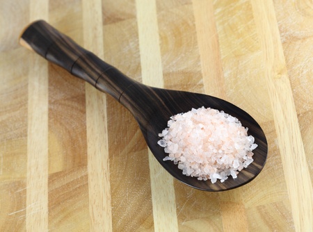 Bolivian Rose Andes Mountain salt in a wooden spoon on a wooden table.の写真素材