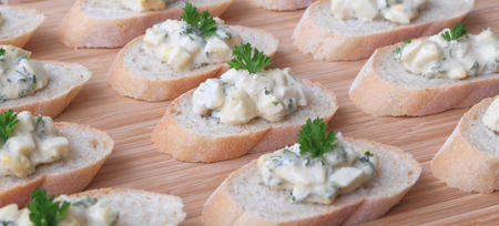 Egg salad served on slices of a baguette.の写真素材