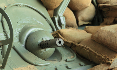 Close-up of the barrel of a machine gun mounted on the front of a military vehicle.の写真素材