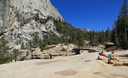 YOSEMITE NATIONAL PARK - SEP 22: Hikers gather at the top of Nevada Falls near the base of Liberty Cap on Sep 22, 2015 in Yosemite National Park. Nevada Falls is located at the west end of Little Yosemite Valley.のeditorial素材