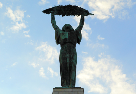 BUDAPEST - SEP 10: Bronze statue of a woman holding a large olive branch on Sep 10, 2013 in Budapest. Designed by Hungarian sculptor Zsigmond Kisfaludi Strobl, it was unveiled in 1947 and sits atop Gellert Hill.のeditorial素材