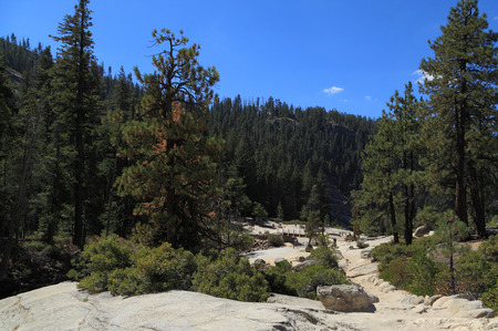 YOSEMITE NATIONAL PARK - SEP 22: Hikers explore the area at the top of Nevada Falls on Sep 22, 2015 in Yosemite National Park. Nevada Falls is located at the west end of Little Yosemite Valley.のeditorial素材