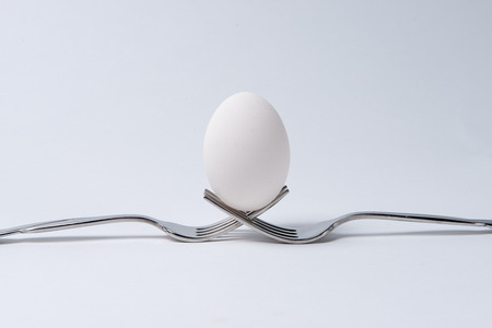 Egg on two shiny Forksの写真素材