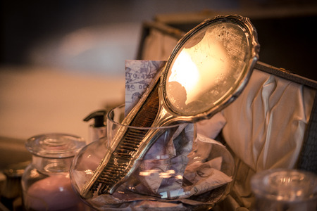 An ladies antique mirror reflects soft warm light from her vanityの写真素材