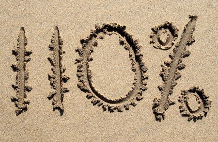 110% written on a sandy beach.の写真素材