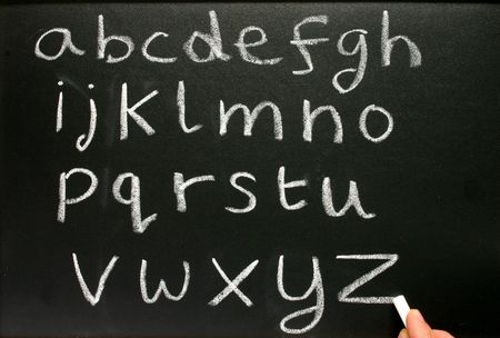 Writing the alphabet on a teachers blackboard.の写真素材