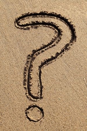 The questionmark symbol drawn in the sand.の写真素材