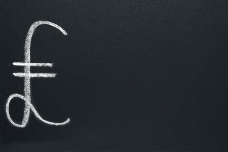 The British Pound currency symbol, written on a blackboard, with space for text.の写真素材