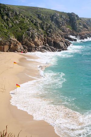 Waves breaking on Porthcurno beach, Cornwall, UK.の写真素材