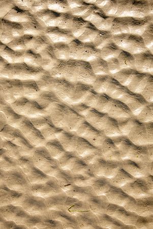 Natural beach sand ripples abstract background.