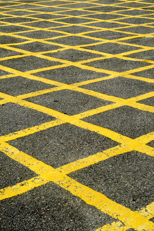 Close up of the yellow lines of a British road box junction.