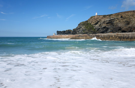Lots of white water with Portreath pier and the Pepperpot in the distance.の写真素材