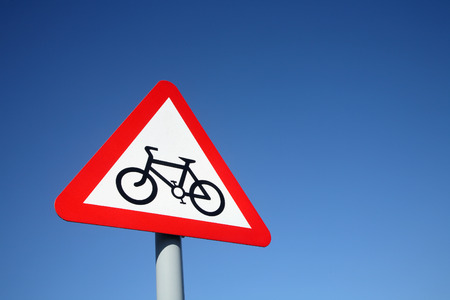 British cycle route ahead warning sign and a big blue sky.の写真素材