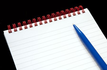 Notepad with red rings and a blue pen on a black background.