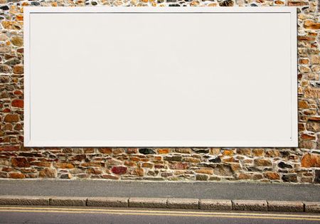 Large white blank billboard on a colorful stone wall.の写真素材