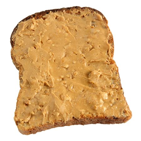 Peanut butter spread thickly on toast isolated on white.の写真素材