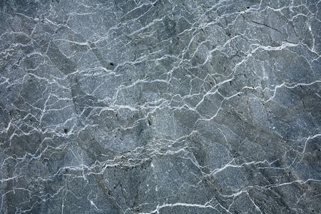 Gray granite stone texture surface worn by the sea.の写真素材