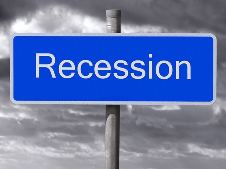 Recession sign and a dark cloudy sky.の写真素材