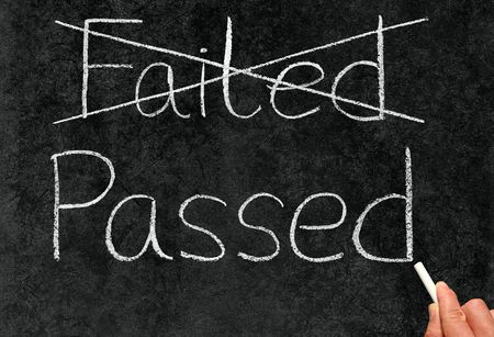 Crossing out failed and writing passed on a blackboard.