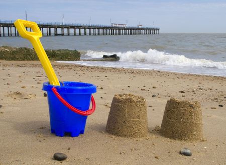 Kids bucket, spade and sandcastles on Felixstowe beach.の写真素材