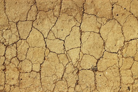 Dry cracked mud close up natural abstract background.