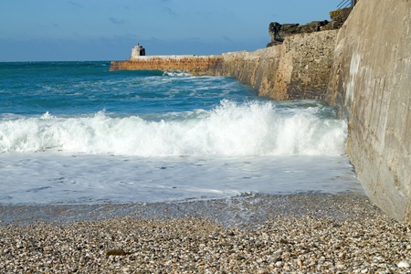 Wave breaking at Portreath Pier, Cornwall UK.の写真素材