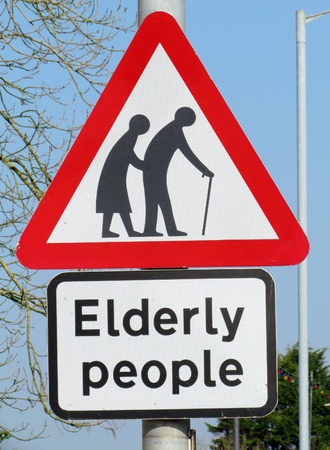 British elderly people crossing road warning sign.の写真素材