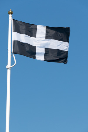 Cornish flag of St. Piran blowing in the wind.の写真素材