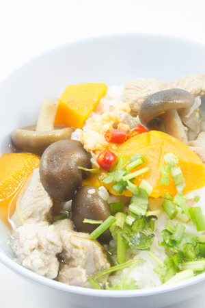 gruel pork mushrooms On a blue bowl white backgruondの写真素材