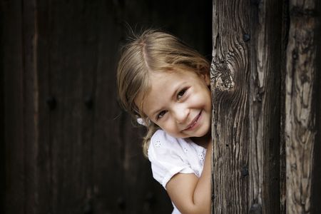 Young girl leaning against door frame の写真素材