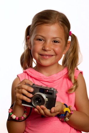 Pretty young girl holding an old cameraの写真素材